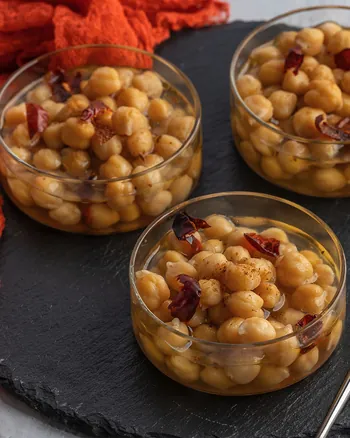 Chickpea and nut jars with gold spoons